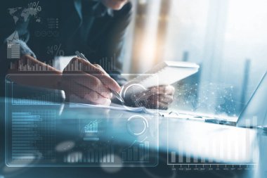 Business strategy analysis concept. Businessman working on laptop computer at modern office with financial graph diagram, business data computer dashboard on virtual screen
