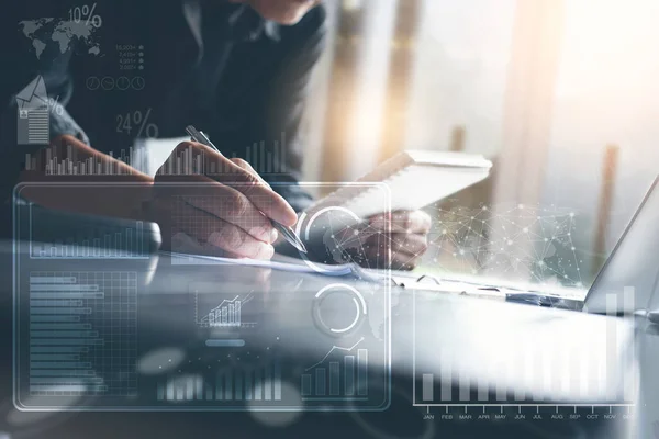 Business strategy analysis concept. Businessman working on laptop computer at modern office with financial graph diagram, business data computer dashboard on virtual screen