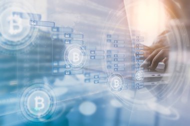 Cryptocurrency, bitcoin, financial blockchain technology concept. Dounble exposure of businessman using laptop computer with bitcoin icons, chain diagram and fintech with modern tech interface