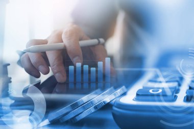 Business analysis and modern technology, accounting and finance investment concept. Double exposure of business man working on digital tablet computer and coins with digital diagram, business data, graph interface