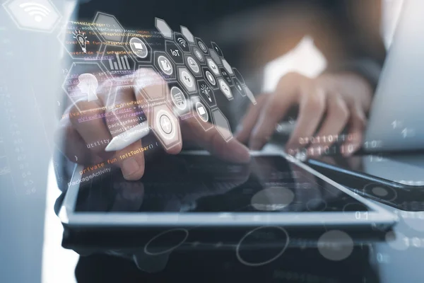Business and technology, IoT Internet of Things, Software development concept. Business man, Web designer working on digital tablet with digital pen, laptop computer. Coding programmer developing mobile apps. Web icons, computer code interface
