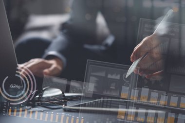 Business analysis and technology , finance investment concept. Businessman, analyzing business data on digital tablet, laptop with digital data, modern computer dashboard, stock market, financial report interface, virtual screen