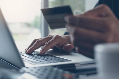 Man online shopping and internet banking on laptop computer by credit card payment, online banking, e commerce, e business, omnichannel or multichannel concept