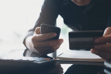 Man online shopping and internet banking on smart mobile phone by credit card payment, online banking, e commerce, e business, omnichannel or mobile banking apps concept