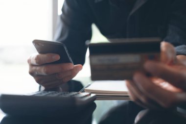 Man online shopping and internet banking on smart mobile phone by credit card payment, online banking, e commerce, e business, omnichannel or mobile banking apps concept