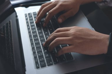 Business man hands typing on laptop computer keyboard, online working, browsing internet, social, media, wireless network communication concept, top view, close up