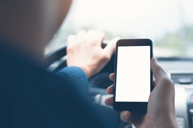 Man using blank white screen mobile smartphone inside a car in sunny day, copy space for your advertisement, vintage tone
