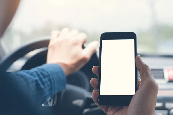 Man using blank white screen mobile smartphone inside a car in sunny day, touching screen or texting, copy space for your advertisement