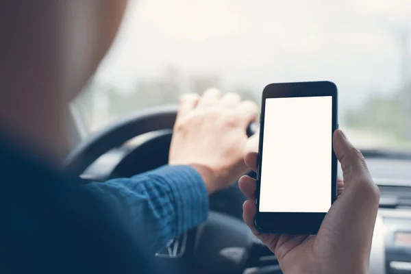 Man using blank white screen mobile smartphone inside a car in sunny day, touching screen or texting, copy space for your products advertisement