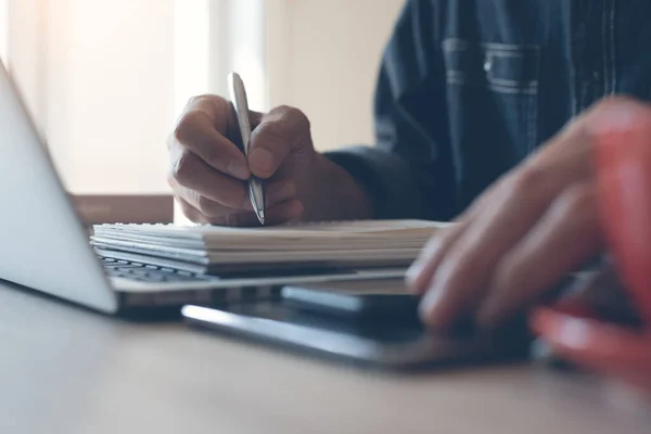 Casual Business Man Writing Notepad Working Laptop Computer Smart Phone — Foto Stock