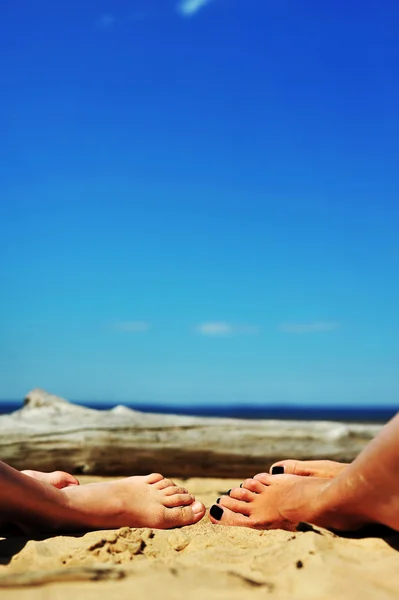 Woman and girls feet in the sand on the beach — Stock Photo, Image