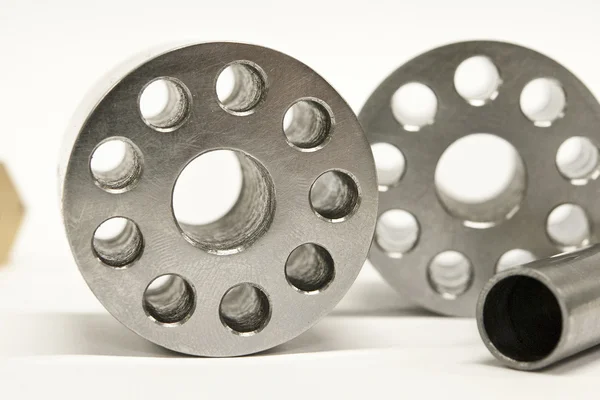 Metal flanges and cylinders.  Milling industry. Close-up. — Stock Photo, Image