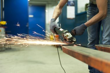 adam testere metal atölyesinde sparks ile eller. metal işleme.