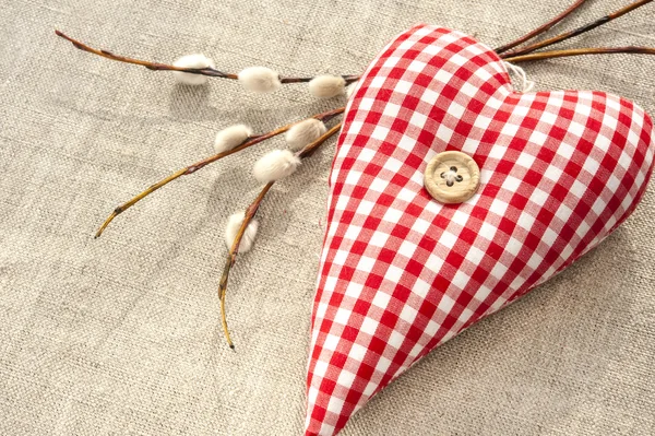 Homemade sewed red cotton love heart with spring willow twig — Stock Photo, Image