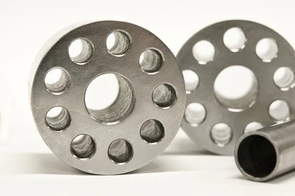 Metal flanges and cylinders.  Milling industry. Close-up. — Stock Photo, Image