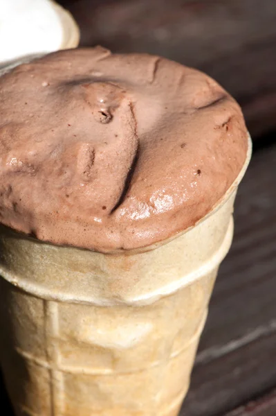 Melting chocolate ice-cream in waffle cup. Outdoors closeup. — Stock Photo, Image