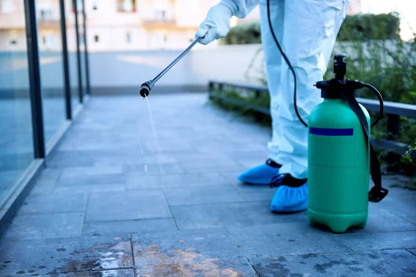 Spraying sanitizer disinfecting and rodent control outdoor. Infection prevention, control diseases spreading and insect extermination. Above view, selective focus. Copy space