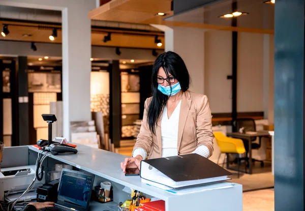 young woman in protective mask in office