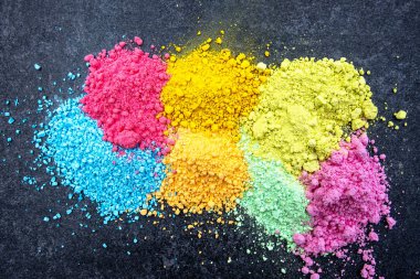 Various dry color powder for painting. Vibrant colors on black background