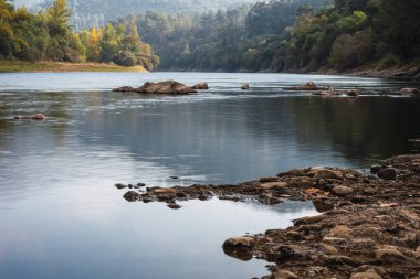 Long exposure of a river with silk effect in the water, with the rocks in focus.