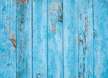 Eski mavi boya katmanlarıyla dikey sıralanmış tahtalardan yapılmış tuval..