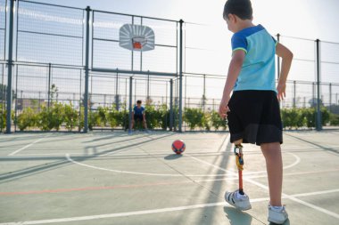 İki arkadaş futbol oynuyor, birinde bacak protezi var ve penaltı atıyor..
