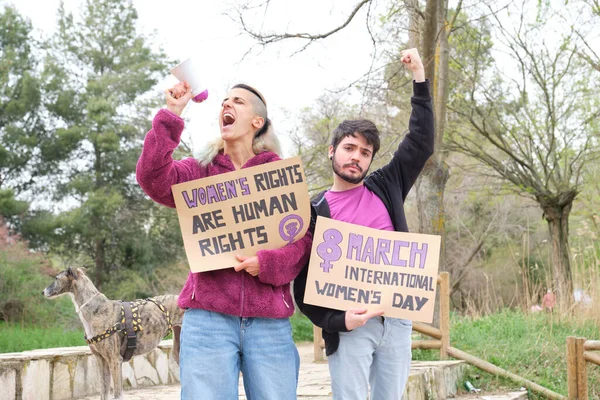 Feminist holding protests banners with feminist slogans and shouting.