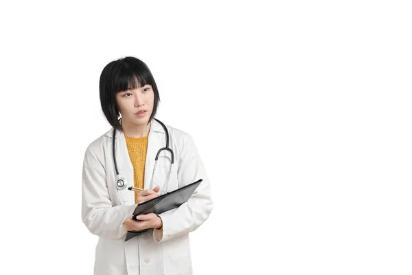 Young asian female doctor listening and writing on a paper, isolated. — Stock Photo, Image