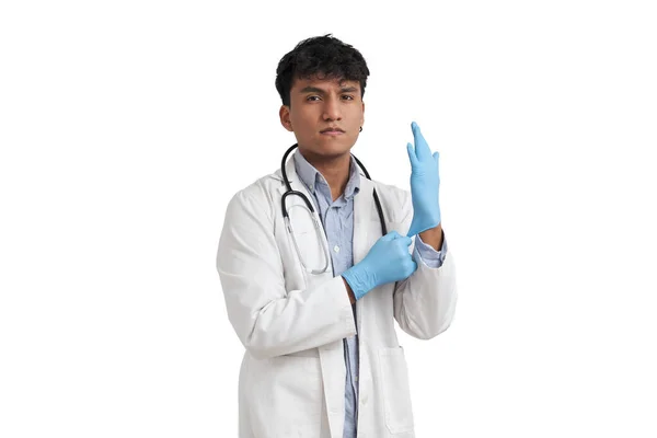 Young peruvian male doctor wearing blue gloves, isolated. — Foto de Stock