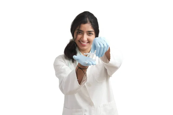 Young Venezuelan female dentist holding invisible dental aligners, isolated. — стокове фото