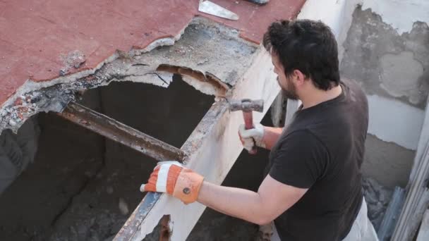 年轻人用木槌把房子的天花板拆了下来 — 图库视频影像
