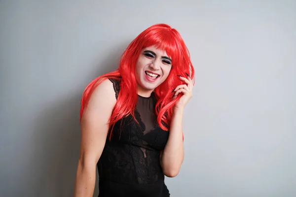 Portrait of gender fluid male dressed as female laughing and looking at camera. LGBTQ queer.