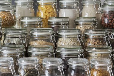 Close up of variety of dry foods, grains, nuts, cereals in glass jars. Zero waste storage concept.