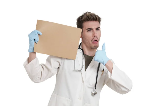 Young Caucasian Male Doctor Thumbs Pointing Board Isolated White Background — Zdjęcie stockowe