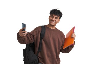 Young peruvian student taking a selfie with folders and backpack. Isolated over white background.