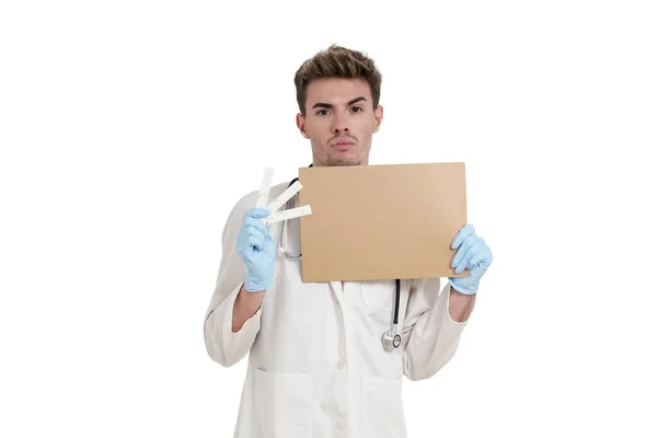 Young Caucasian Male Doctor Holding Board Negative Covid Antigen Test — Zdjęcie stockowe