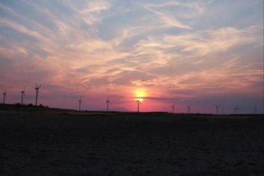 Sunset timelapse of the wind turbines at wind farm in Zaragoza, Spain. Alternative energy sources.