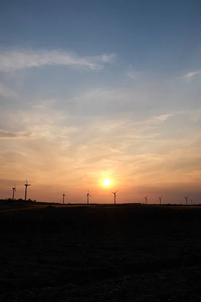 Wind turbines at the sunset in the wind farm in Zaragoza, Spain. Alternative energy sources.