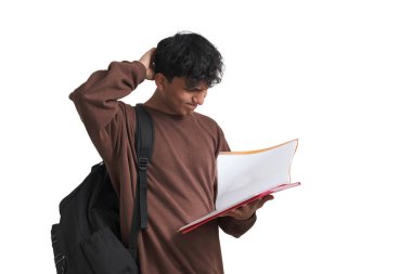 Young peruvian student confused about his class notes. Isolated over white background.