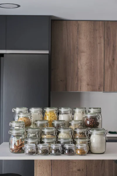Variety of dry foods, grains, nuts, cereals in glass jars. Zero waste storage concept.