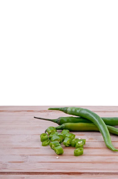 Chopped green chillies on chopping board — Stock Photo, Image