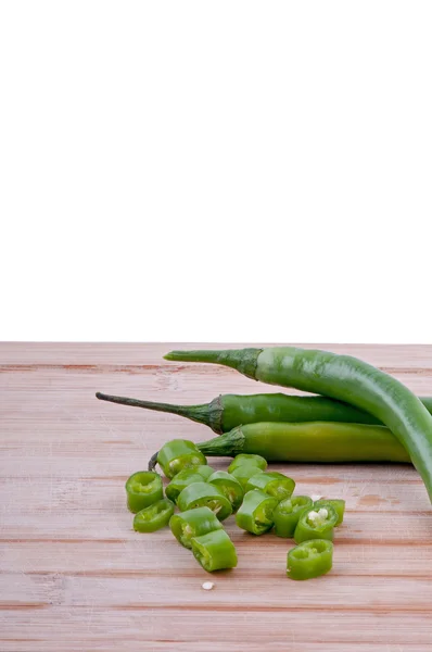 Chopped green chillies on chopping board — Stock Photo, Image