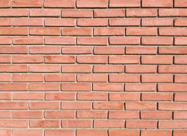 Brick wall of a reddish hue, texture, design