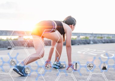 Concept of The technology to check health while exercising,woman in starting position preparing to run, Readiness of leaders, visions and new ideas. Ideas step into a new world. And look forward to success in 2023 for a new life.