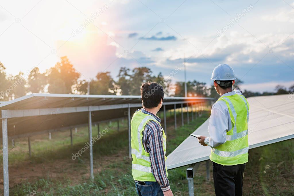 Architectural engineer working on solar panels and photovoltaic farms at a construction site, meeting, discussing, designing, planning, clean energy concept.