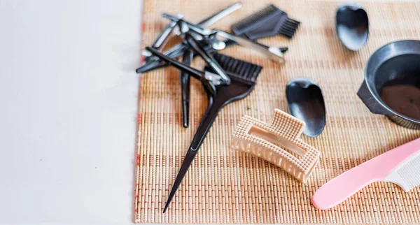 Close-up of hairdressing tools on a wooden table.