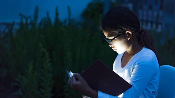 Close-up of the Bible in the hands of a beautiful girl ,The light from the scriptures hits the young woman's face, the concept of entering the church to pray.