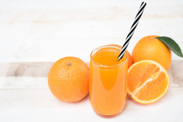 fresh orange juice with orange fruit on wood white
