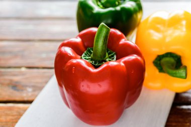 The sweet pepper, bell pepper Red Green Yellow on wood background