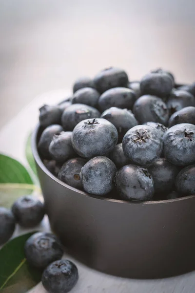 blueberries on wood white background in bowl